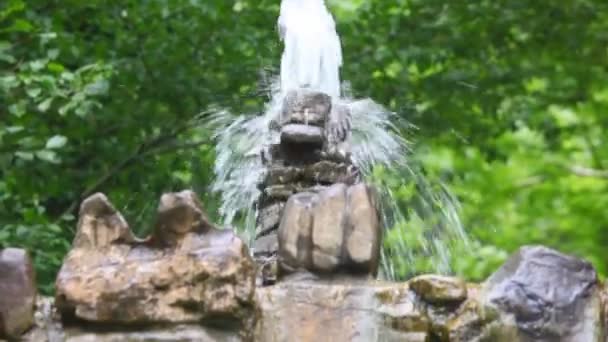 Artificial stone cascades waterfall in forest, panning downwards — Stock Video