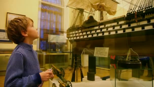 Jongen Neem een goede blik op model van boot in museum — Stockvideo