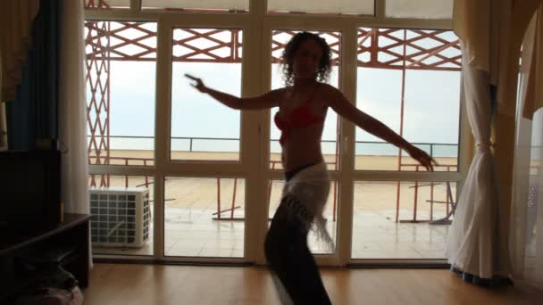 sexy junge kaukasische Frau tanzt Bauchtanz drinnen
