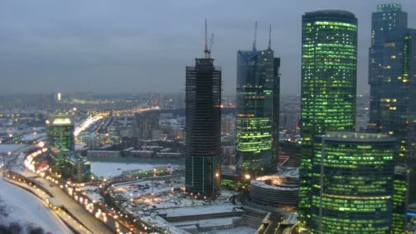 Modern city: skyscrapers, movement on highway. Gradually darkens. Time lapse. — Stock Video