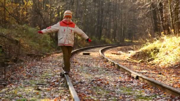 Niño caminando en ferrocarril — Vídeos de Stock