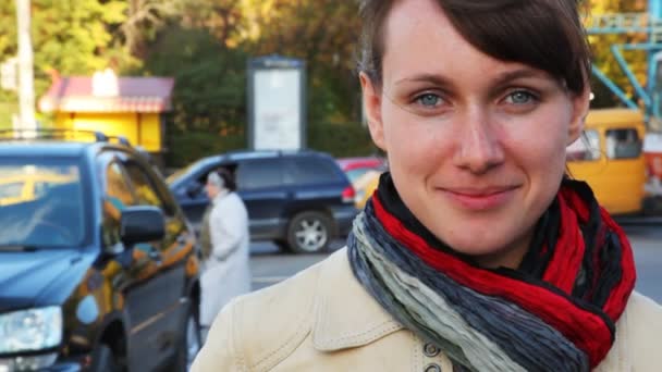 Портрет улыбающейся женщины в уличных городах перед идущими автомобилями — стоковое видео