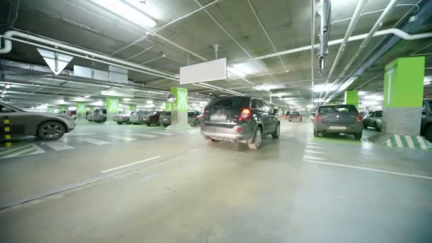 Cars moving in underground cars park from camera — Stock Video