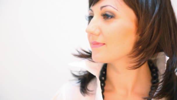 Portrait of laughing young woman dressed white blouse on white background — Stock Video