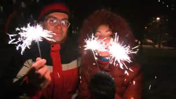 Young woman and man with sparklers, night outdoor — Stock Video