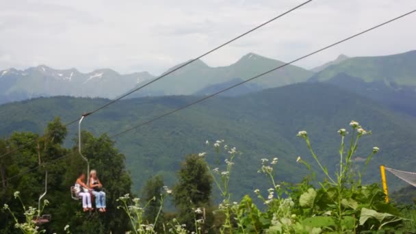 Tourists on moving funicular above forest — Stock Video