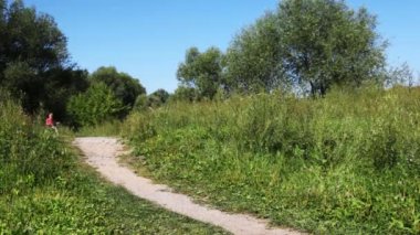 Çocuk pembe yelek ve adam sırayla mavi spor kıyafeti Bisiklet park yolundaki üzerinde geri götürmek için git