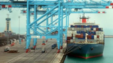 Loading of cargoes on the cargo ship on landing stage. Time lapse