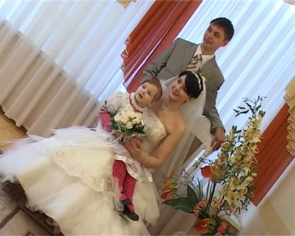 Bride with girl and groom photographed in registry office — Stock Video