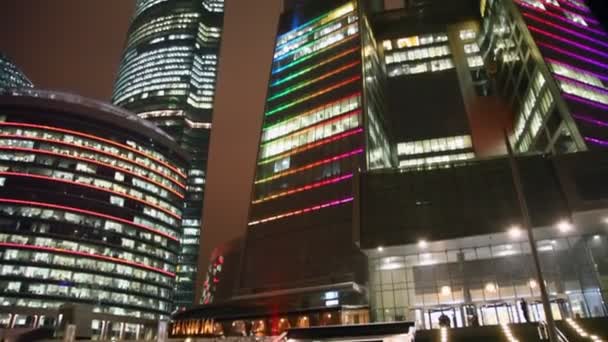 Sight upwards on high shone skyscrapers of business centre of Moscow at night — Stock Video