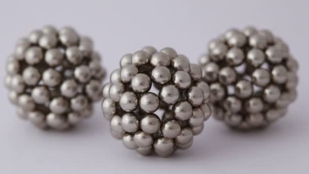 Three figures consisting of metallic balls are shooted with different exposure — Stock Video