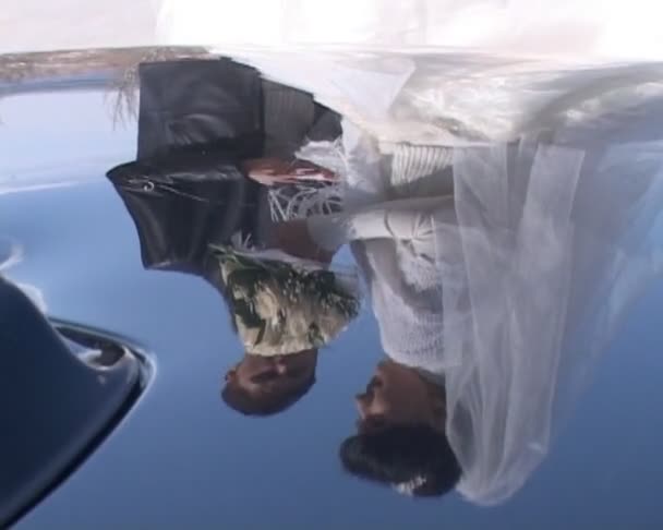 Bride mouths candy and groom in suit — Stock Video