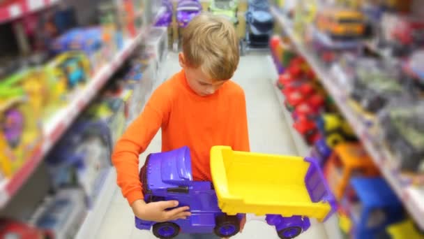 Boy with toy auto truck in supermarket — Stock Video