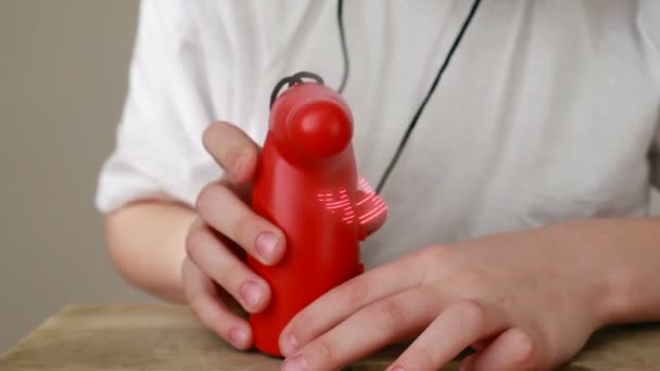 Boy presses button and propeller toy with word Family rapidly spins — Wideo stockowe