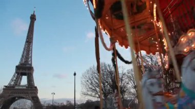 Carousel in night paris, illuminated eiffel tower in background, Paris, France.