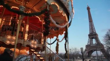 Carousel in night paris, illuminated eiffel tower in background, Paris, France.