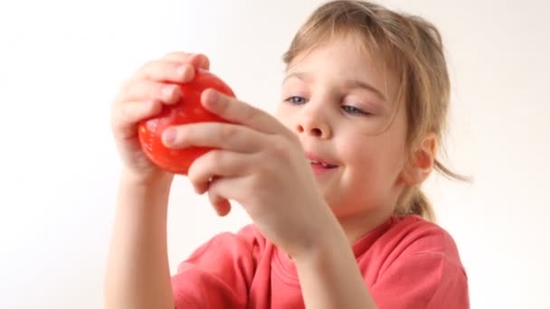 Little girl plays with kitchen timer in strawberry form — Stock Video