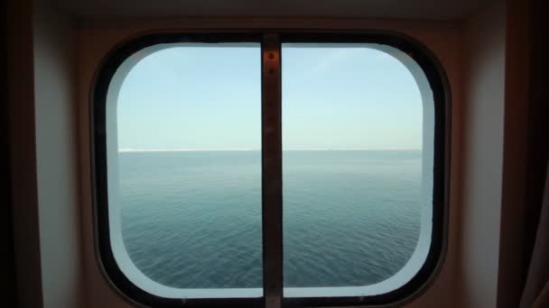 View at sea through sidelight of passenger cabin — Stock Video