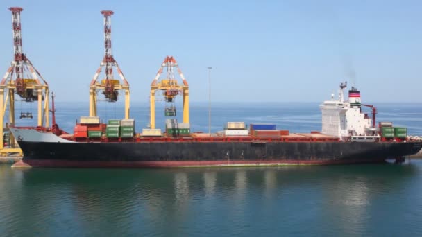 Cargoship with containers on shipboard in seaport — Stock Video