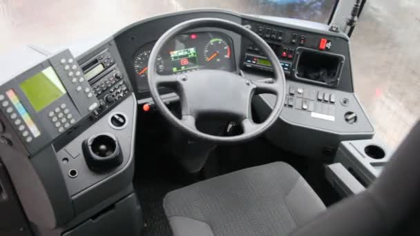 Cab of bus shown from inside, with its dashboard and steering wheel — Stock Video