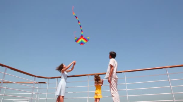 Bottom view on family flying kite on deck of ship — Stock Video