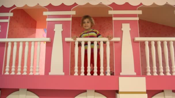 Girl stands on second level of children house — Stock Video