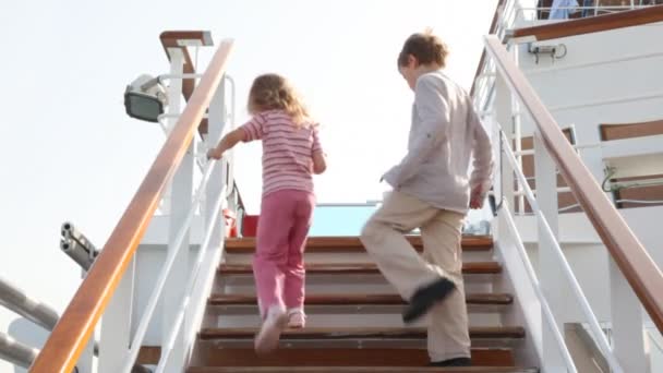 Children are going up ladder on deck of ship and disappearing — Stock Video