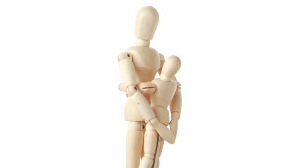 Rotating wooden figures of parent embracing his child — Stock Video