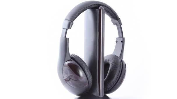 Black headphones rotating on white background — Stock Video