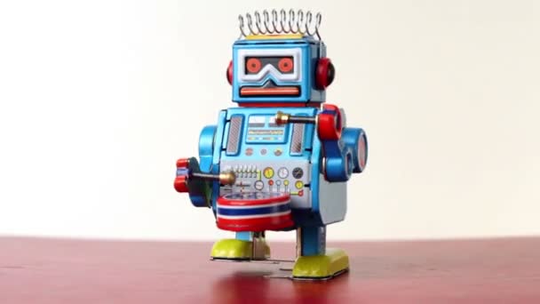 Closeup of blue clockwork robot walks on table, beats drum — Stock Video