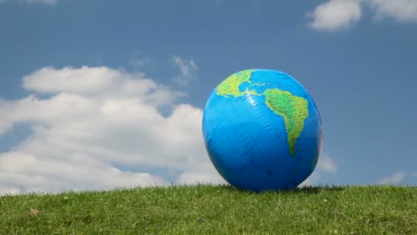 Globus aussehender aufblasbarer Ball auf Wiese — Stockvideo
