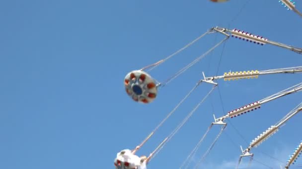 Part of merry-go-round on blue sky background at sunny day — Stock Video