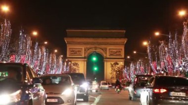 Cars move on the Champs-Élysées near Arc de Triomphe