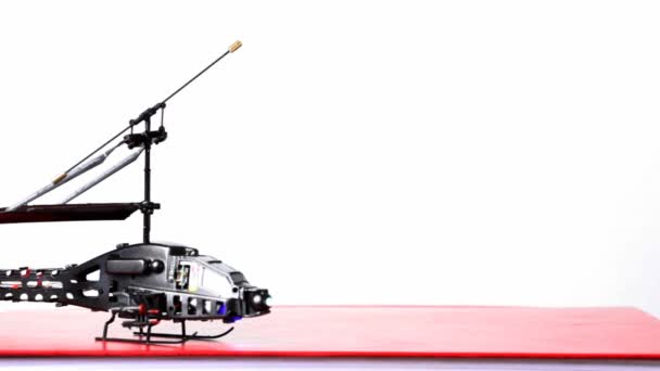 hélicoptère jouet est sur la table, ses lames commencent à tourner, puis vole vers le haut 