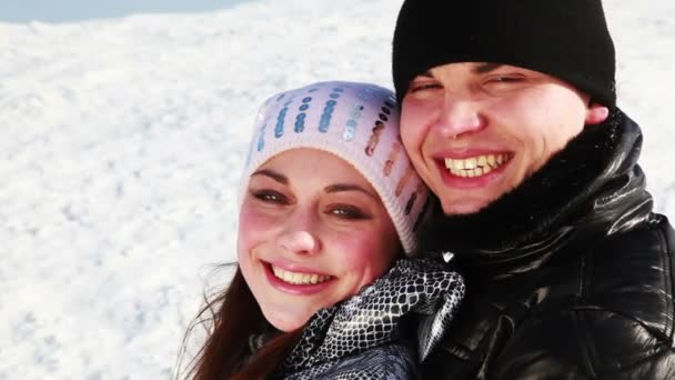 Young boy and girl hugging stand outdoors in winter — Stock Video