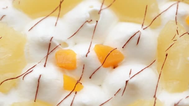 Closeup of cream with fruit slices — Stock Video