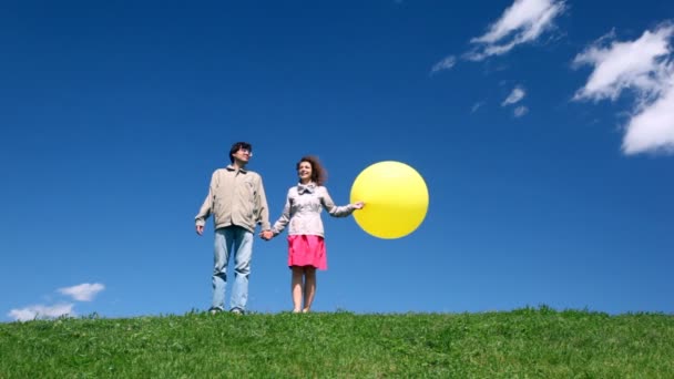 Man with woman holding hands with bubble stand on hill — Stock Video