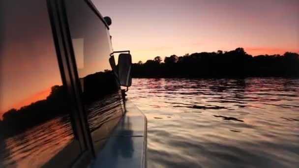 Boat floating on river lit night sky — Stock Video