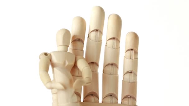 Rotation of toy giant arm and little toy man on its thumb — Stock Video