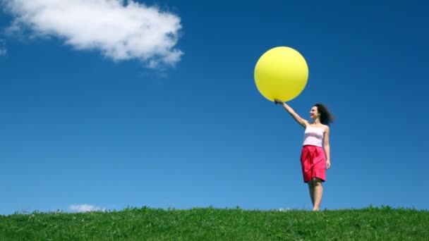 Woman looks at bubble in hand on meadow — Stock Video