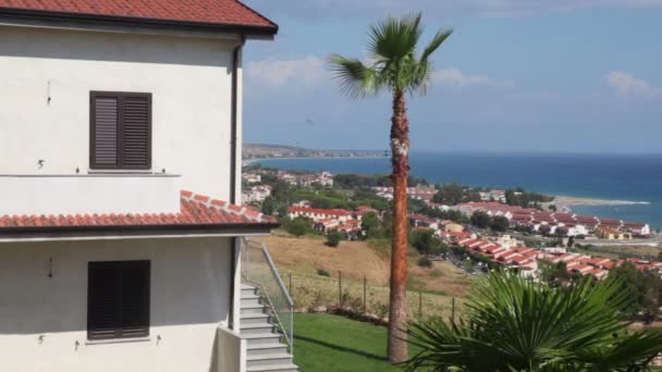 Coastal town placed on sea shore, view from hill — Stock Video