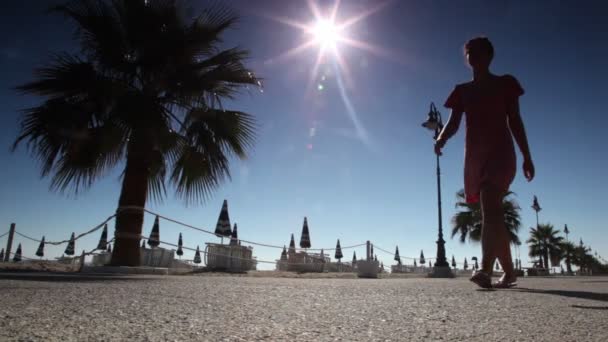 Woman walking by street near beach — Stock Video