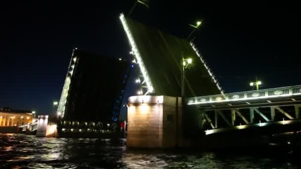 Raised drawbridge night on Neva illuminated — Stock Video