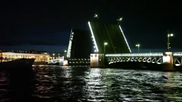 Dry cargo ship floats through raised bridge night on Neva river — Stock Video