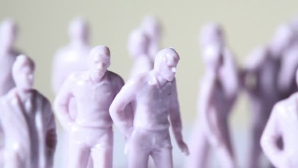 Group of little unpainted toy human stand — Stock Video