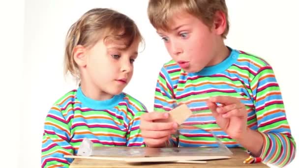 Two children boy and girl unpacked part of the model plane — Stock Video