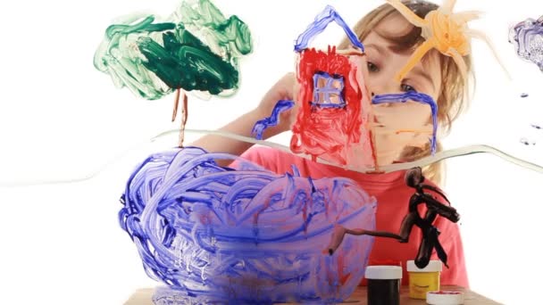 Little girl paint himself at home in picture on transparent glass — Stock Video