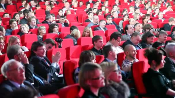 People sit in auditorium on ceremony of Second National Premium Big Digit — Stock Video