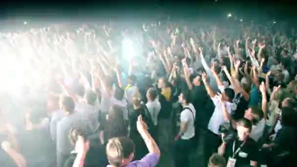 People jump hands up at rave party in large hall — Stock Video