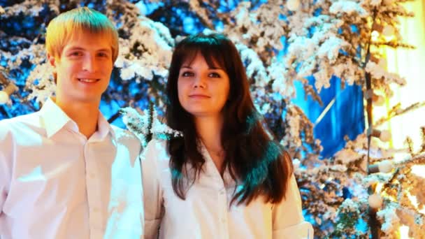 Young couple stands in winter forest — Stock Video